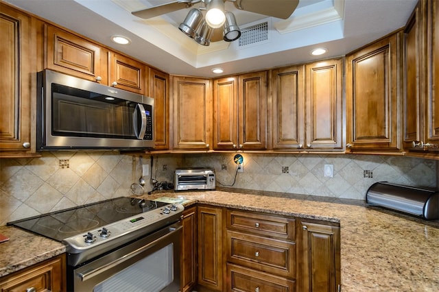 kitchen with backsplash, stainless steel appliances, and crown molding