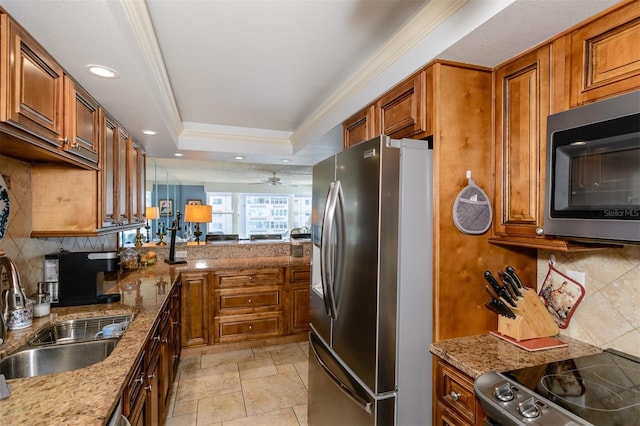 632 Edgewater Dr Unit 532, Dunedin, FL 34698 - kitchen with appliances with stainless steel finishes, a sink, brown cabinets, and recessed lighting
