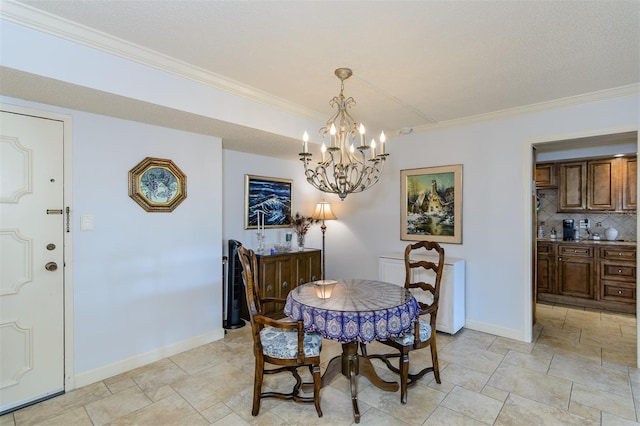 dining room with a chandelier, a textured ceiling, and ornamental molding