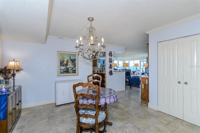 dining space with ornamental molding, a textured ceiling, and an inviting chandelier