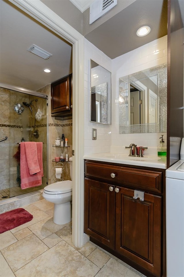 632 Edgewater Dr Unit 532, Dunedin, FL 34698 - bathroom featuring toilet, a shower stall, vanity, tasteful backsplash, and washer / dryer