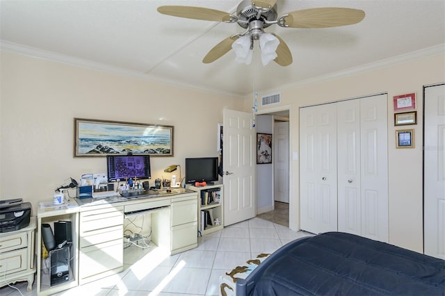 tiled bedroom with a closet, ceiling fan, and crown molding