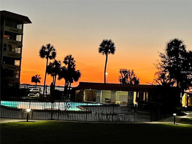 view of pool at dusk