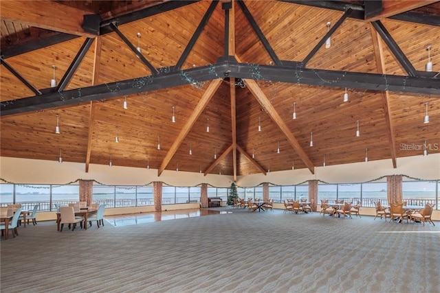 632 Edgewater Dr Unit 532, Dunedin, FL 34698 - misc room featuring carpet, high vaulted ceiling, healthy amount of natural light, wooden ceiling, and beam ceiling