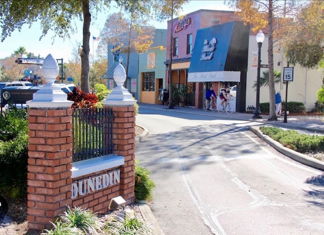 632 Edgewater Dr Unit 532, Dunedin, FL 34698 - view of asphalt street featuring street lighting, sidewalks, curbs, and traffic signs