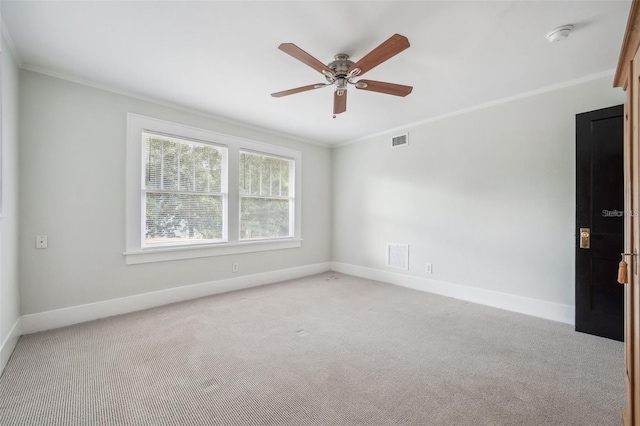 empty room with ornamental molding, light carpet, and ceiling fan