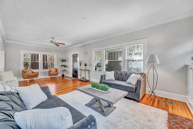 living room with crown molding, light hardwood / wood-style floors, and ceiling fan