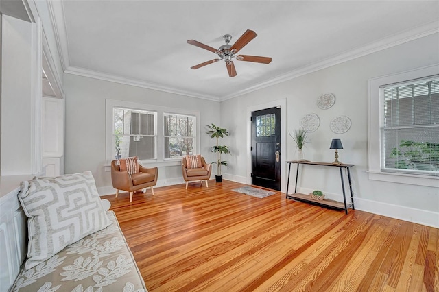 interior space featuring ornamental molding, wood-type flooring, and a healthy amount of sunlight