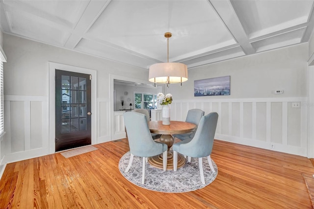 dining room with coffered ceiling, beam ceiling, and light wood-type flooring