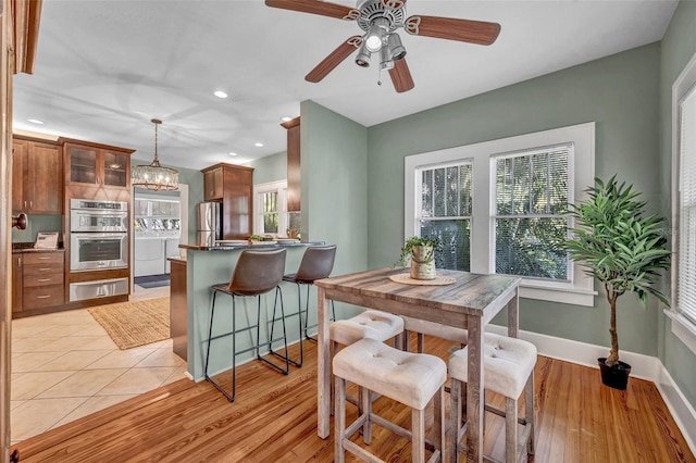 tiled dining room with ceiling fan