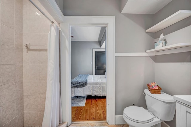 bathroom with curtained shower, tile patterned floors, and toilet