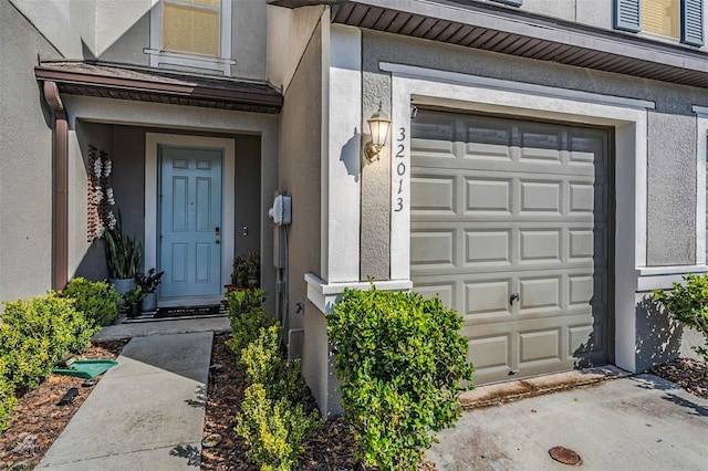 doorway to property with a garage