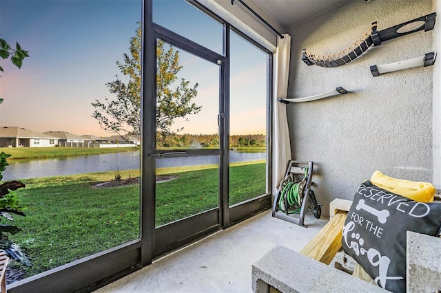 sunroom / solarium with a water view