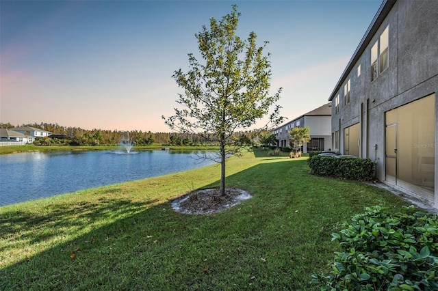 yard at dusk with a water view