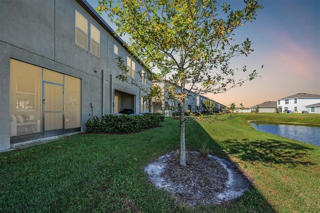 yard at dusk with a water view