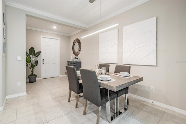 dining area featuring light tile patterned floors and crown molding