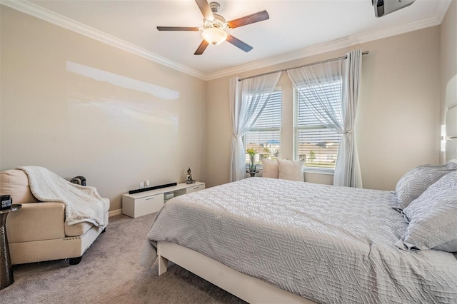 carpeted bedroom featuring ceiling fan and crown molding