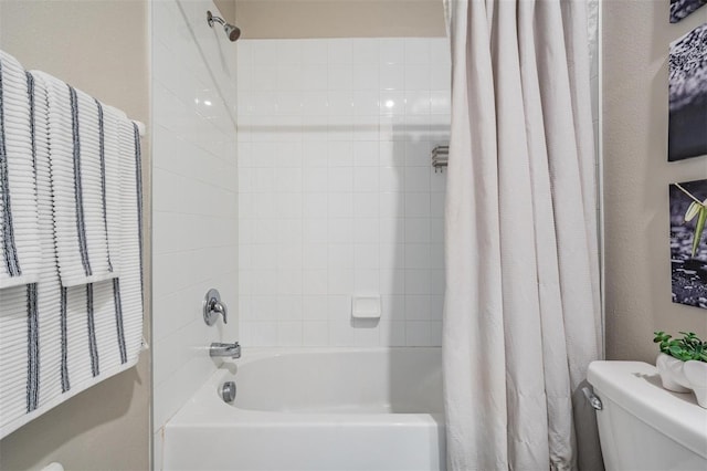 bathroom with shower / tub combo with curtain and toilet