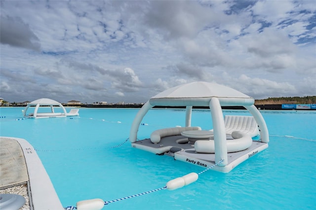 view of pool with a water view