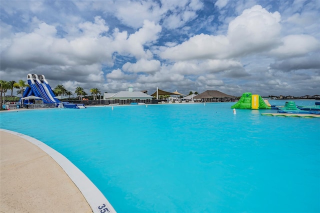 view of swimming pool with a water view