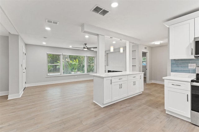 kitchen with white cabinets, light hardwood / wood-style floors, and ceiling fan