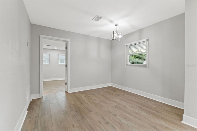 spare room featuring light wood-type flooring