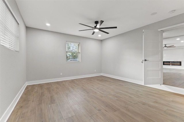 spare room with light hardwood / wood-style flooring and ceiling fan