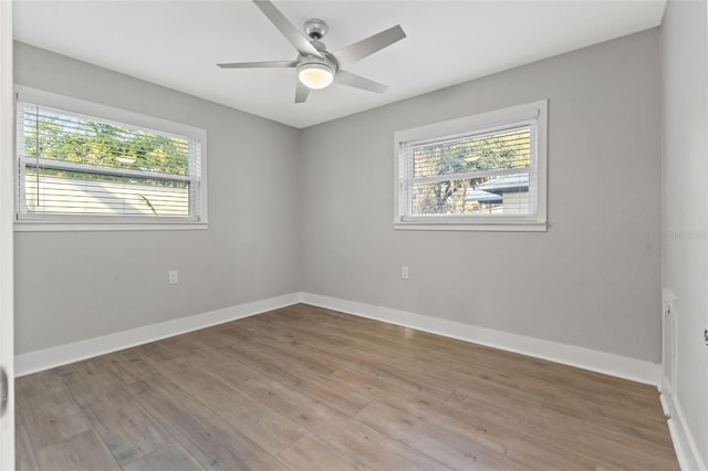 empty room featuring ceiling fan and hardwood / wood-style floors