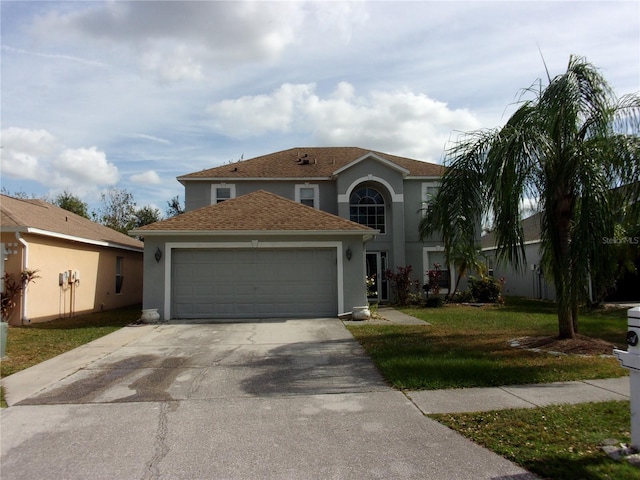 view of front property featuring a garage and a front lawn