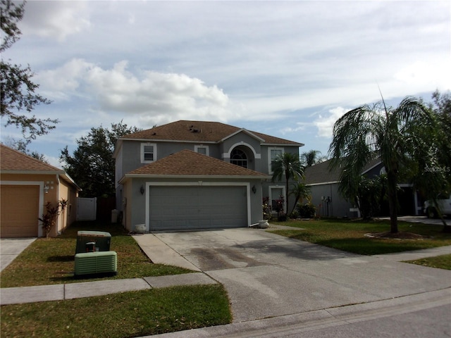 view of front of property with a front yard and a garage