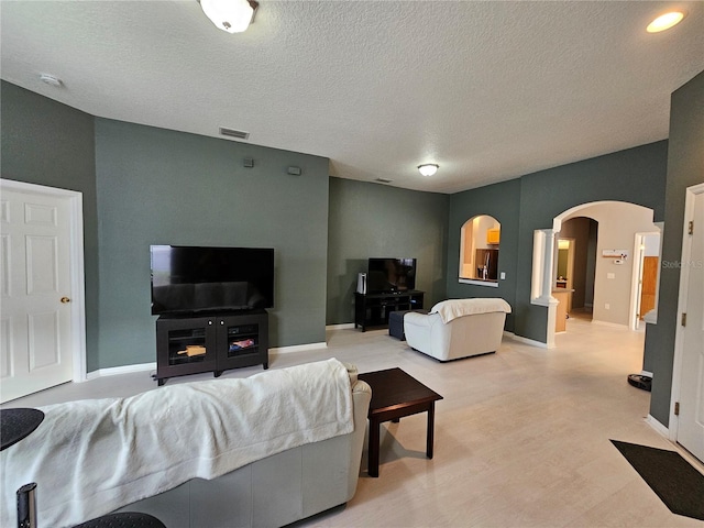 carpeted living room featuring a textured ceiling