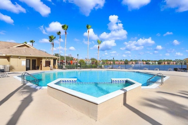 view of swimming pool with a community hot tub and a patio