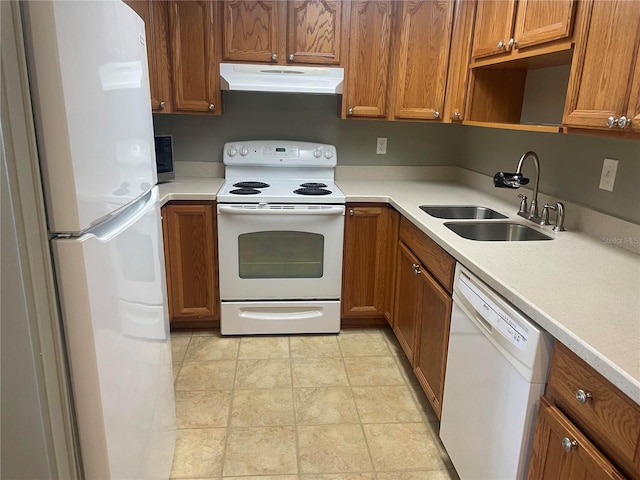 kitchen featuring light tile patterned floors, white appliances, and sink