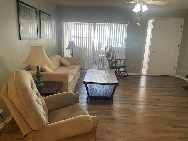 living room featuring ceiling fan and dark hardwood / wood-style flooring