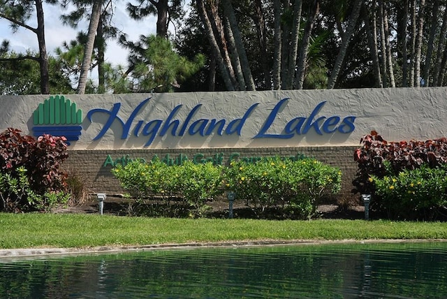 community / neighborhood sign with a water view