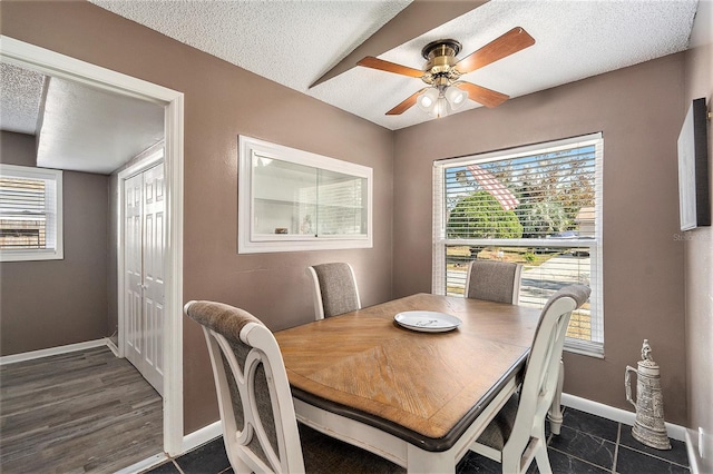 dining room featuring ceiling fan, dark hardwood / wood-style flooring, and a textured ceiling