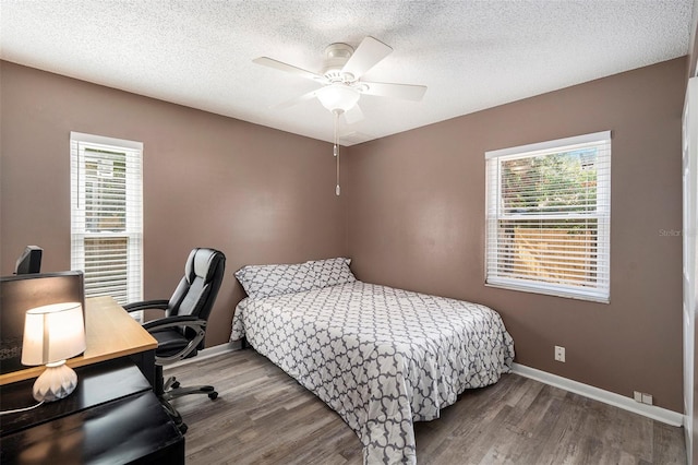 bedroom featuring ceiling fan, a textured ceiling, and hardwood / wood-style flooring