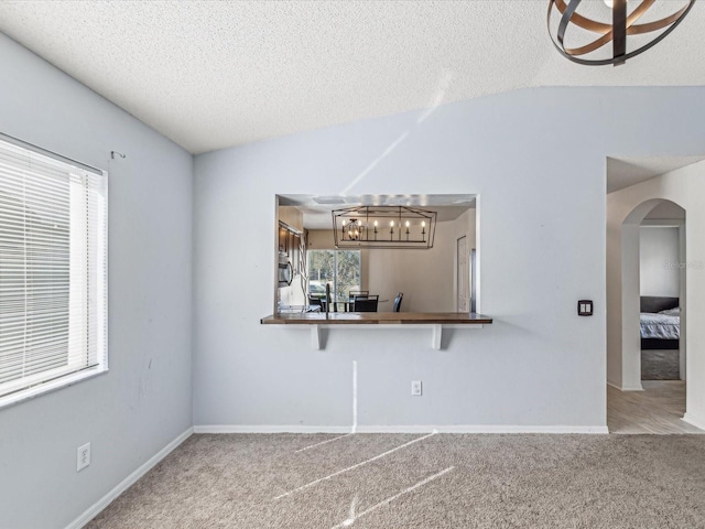 interior space with lofted ceiling and a textured ceiling