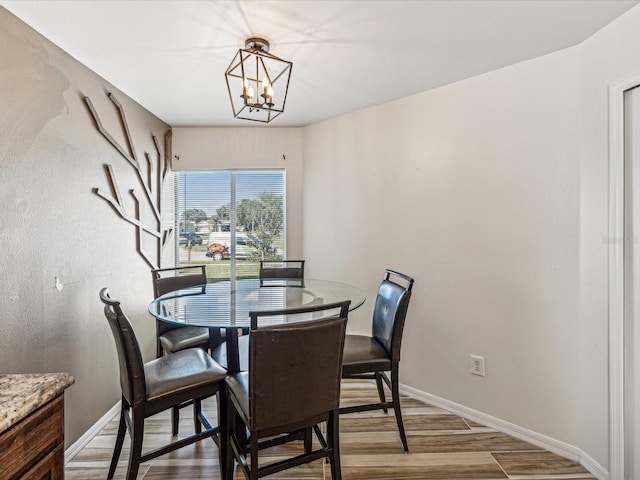 dining area featuring hardwood / wood-style flooring and a notable chandelier