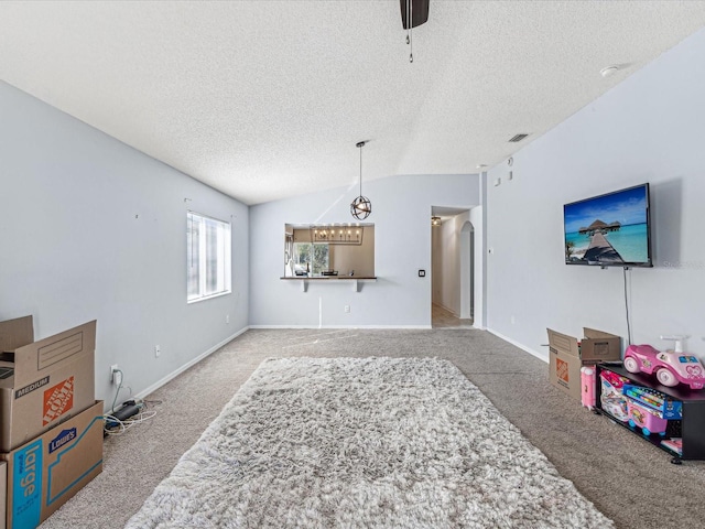 carpeted living room with a textured ceiling, ceiling fan, and lofted ceiling