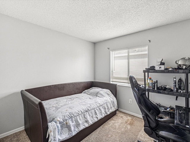 carpeted bedroom featuring a textured ceiling