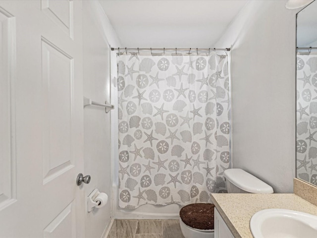 full bathroom with shower / tub combo, vanity, and toilet