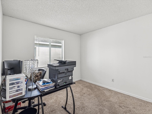 carpeted office featuring a textured ceiling