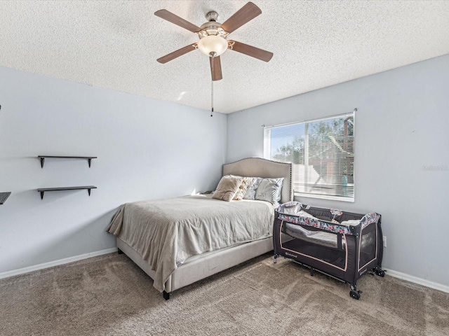 bedroom featuring carpet flooring, ceiling fan, and a textured ceiling