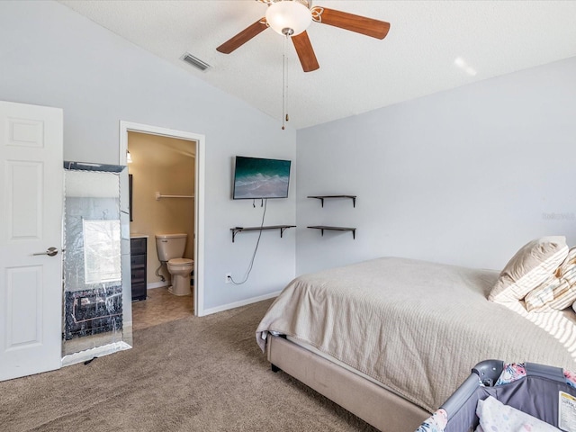 carpeted bedroom with a textured ceiling, ensuite bathroom, ceiling fan, and lofted ceiling