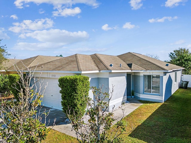 single story home featuring a garage and a front lawn