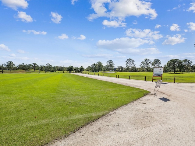 view of property's community with a lawn