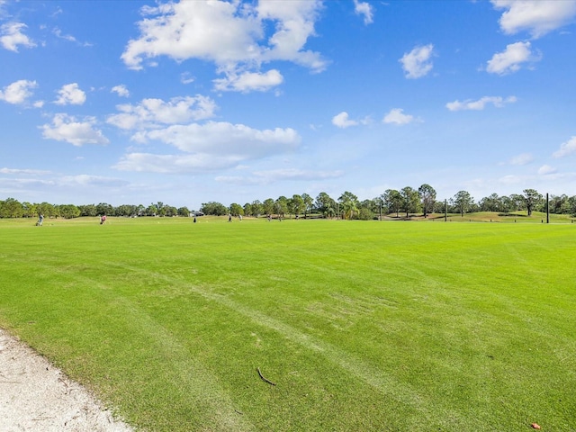 surrounding community featuring a yard and a rural view