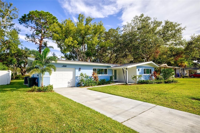 ranch-style home featuring a garage and a front yard