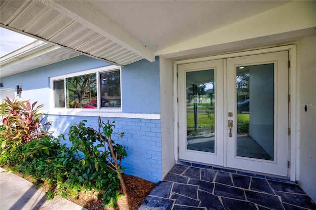 view of exterior entry featuring french doors